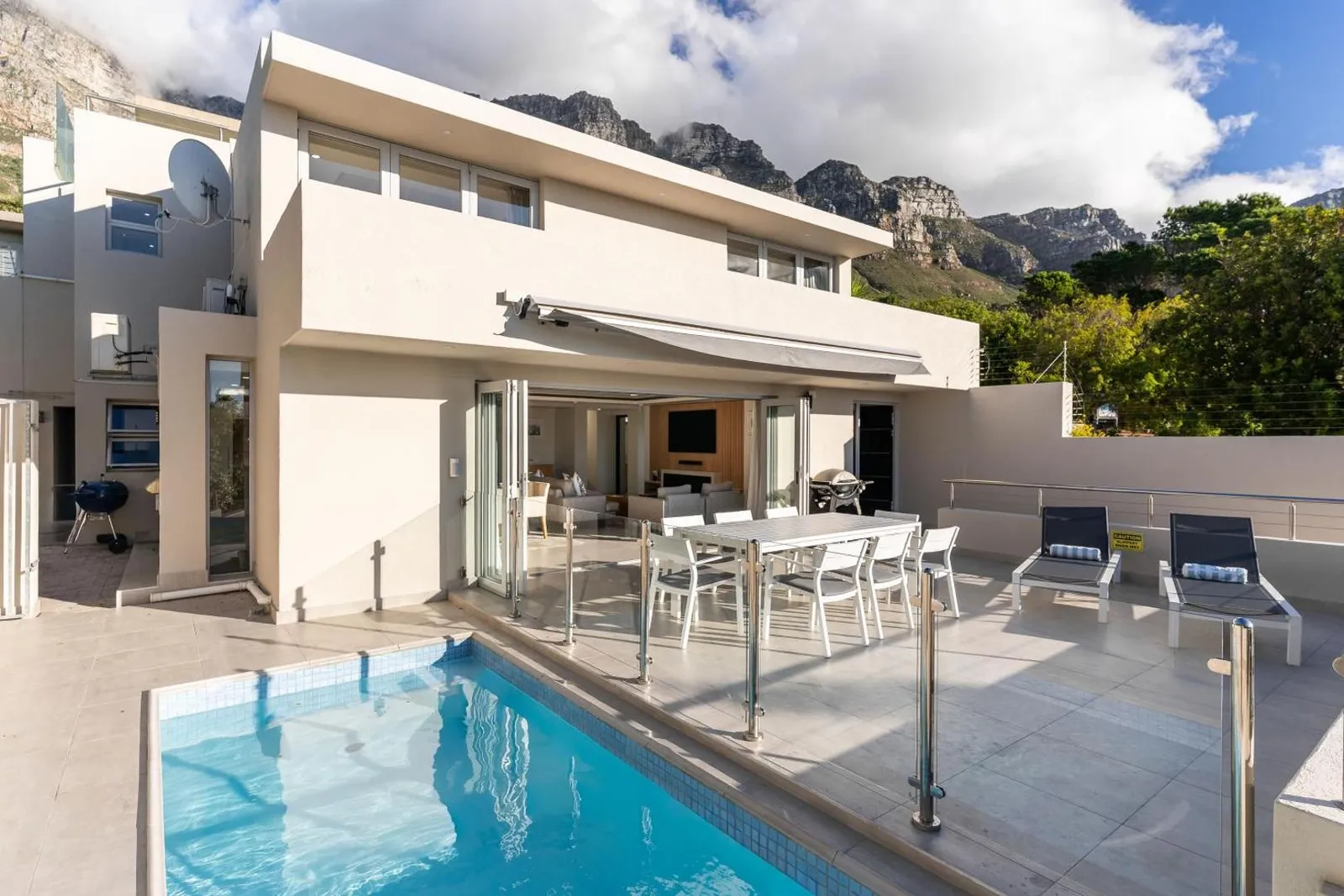 Villa exterior and pool with the mountain range behind